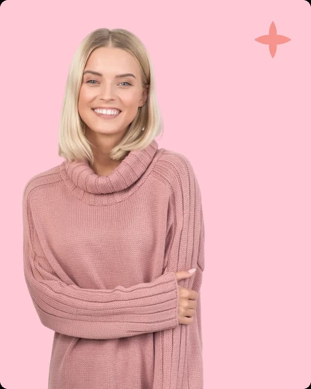 A woman in a pink jumper smiling