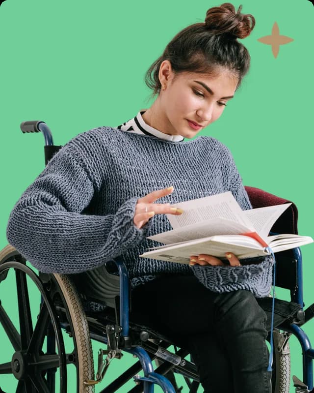 A young woman reading a book in her wheelchair