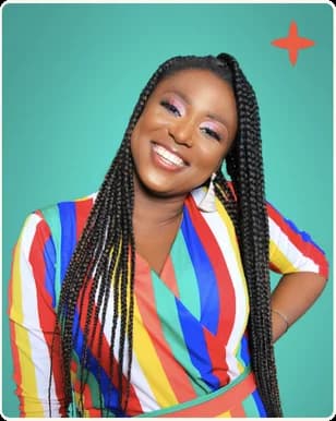 A woman with long braids in a bright striped top