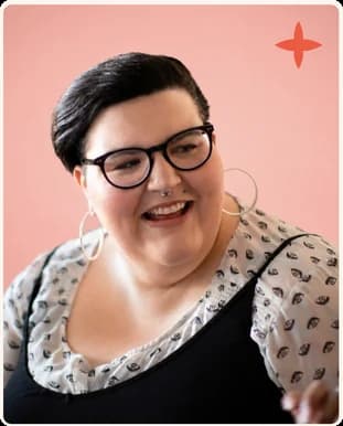 A woman in glasses laughing