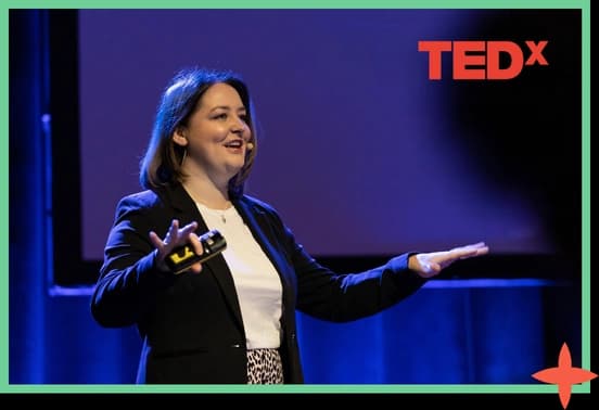 Holly McLoughlin speaking on a TEDx stage